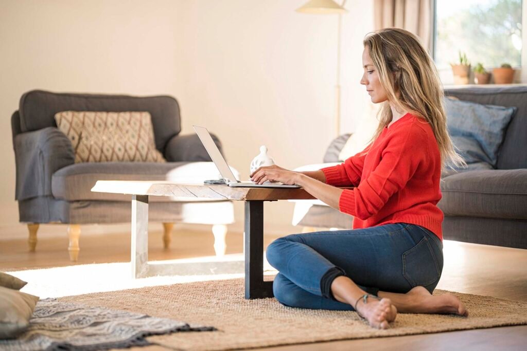woman-using-laptop-on-coffee-table-at-home-6QGZXN5.jpg